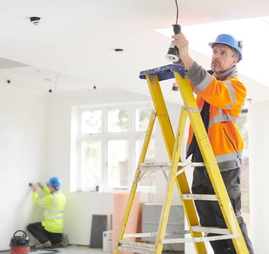 A handyman repairing kitchen light in tampines sg