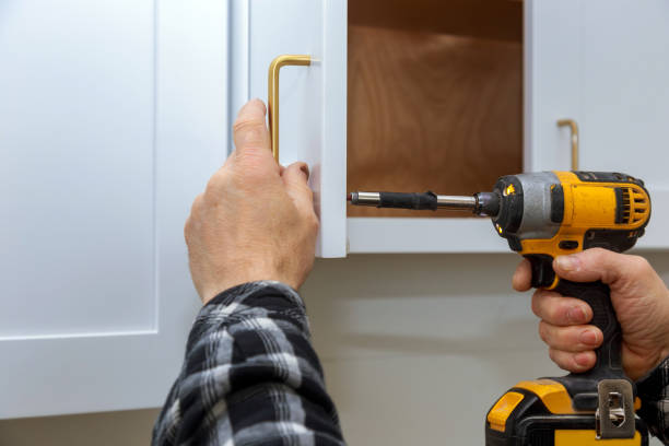 The installing a furniture handle process of assembling kitchen cabinet