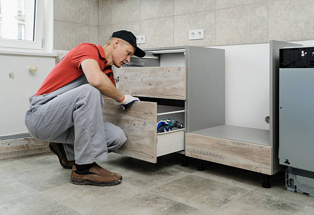 a professional handyman worker repairing a kitchen cabinets