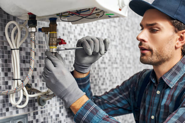 Wrench always with you. Worker set up electric heating boiler at home. Close-up of young handyman