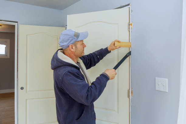 Handyman install the new door in the interior room construction of housing