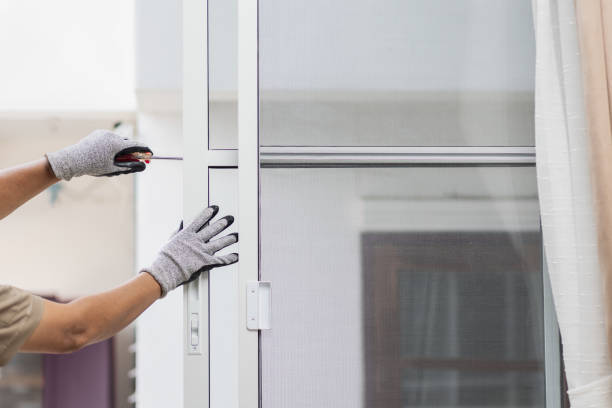 Construction worker repairing the sliding window.