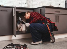 a handyman in singapore doing assesment kitchen pipes