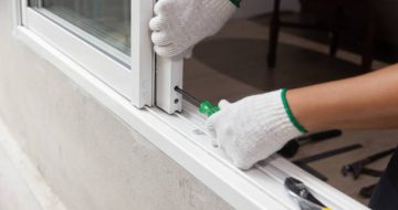 Construction worker repairing the sliding window.