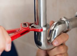 a plumber handyman in singapore fixing kitchen sink pipe